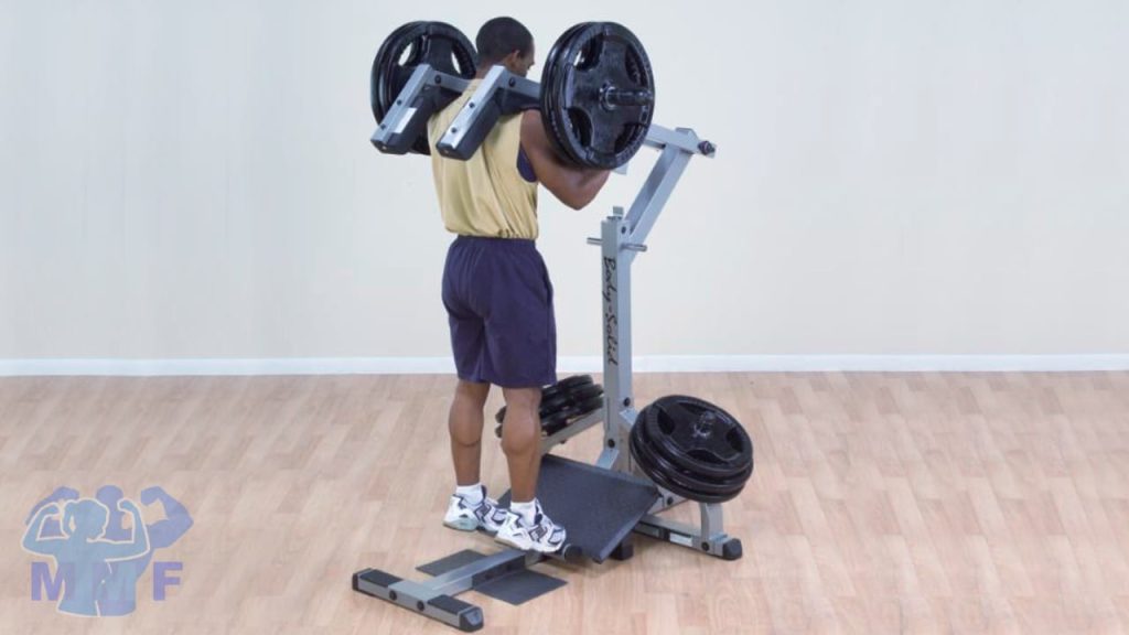 Man on a standing calf raise machine with white background.